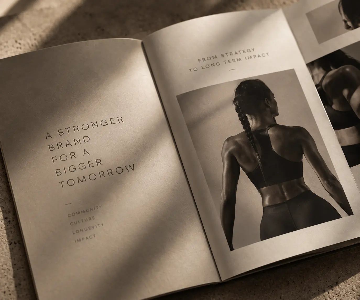 Open editorial brand book featuring a female activewear athlete